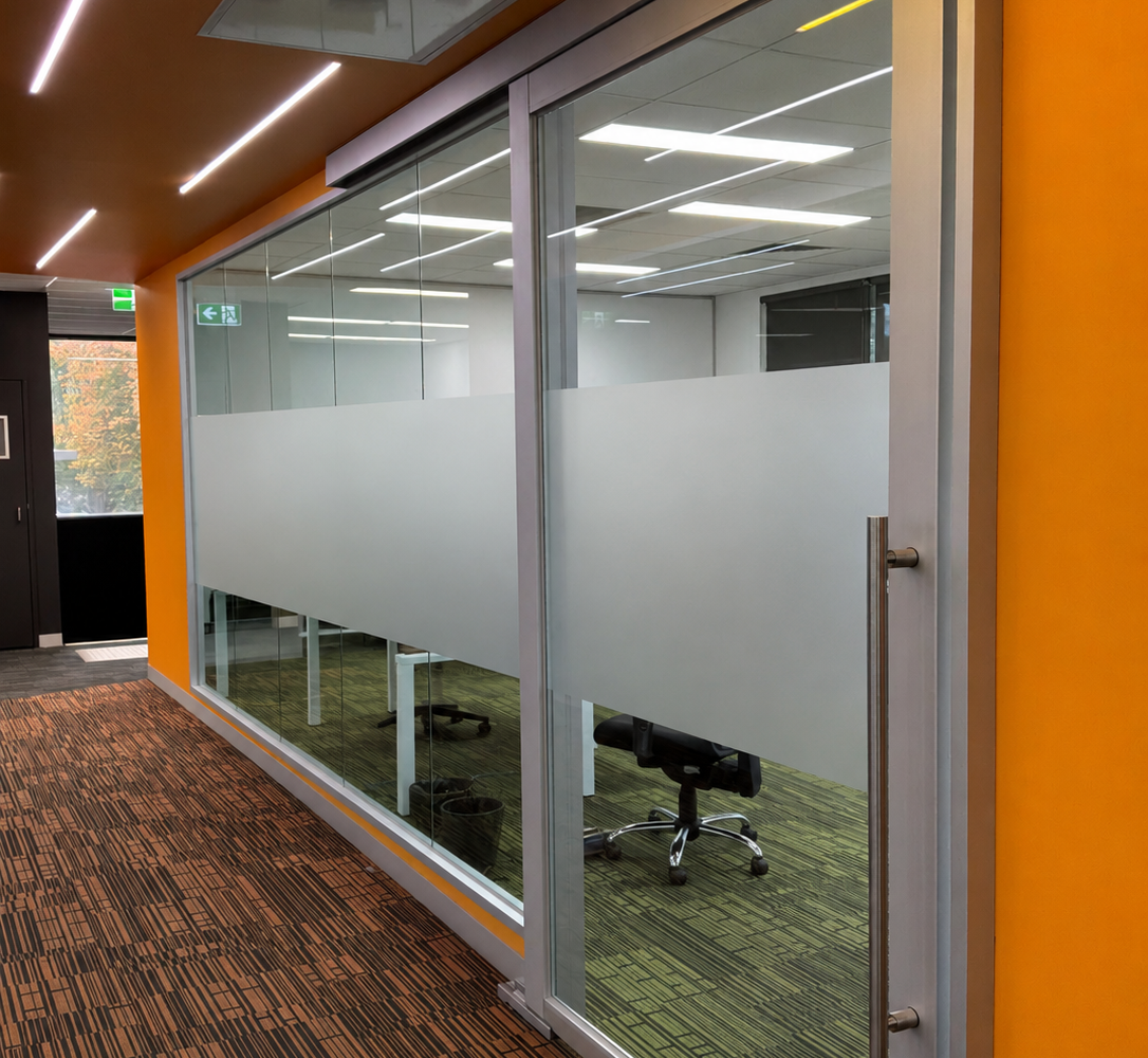 Office window frosting installation providing privacy for meeting rooms and commercial office spaces in Kew.