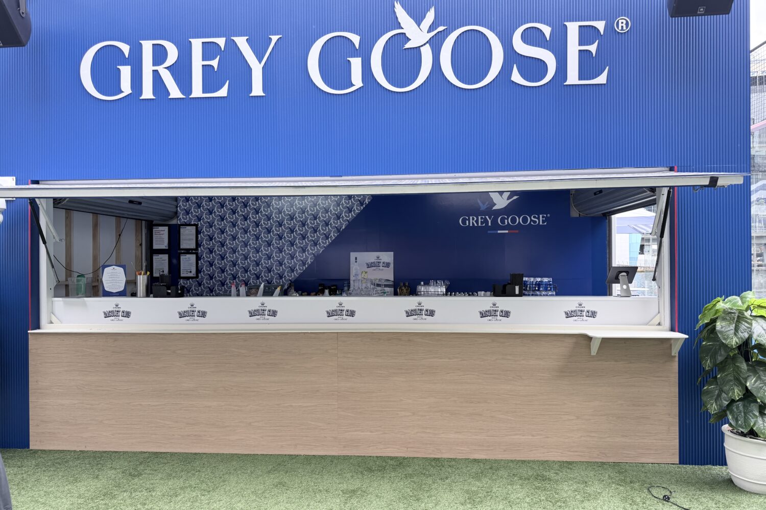 Custom hospitality venue branding featuring large-format 3D lettering and branded wall graphics installed on a Grey Goose beverage service bar.
